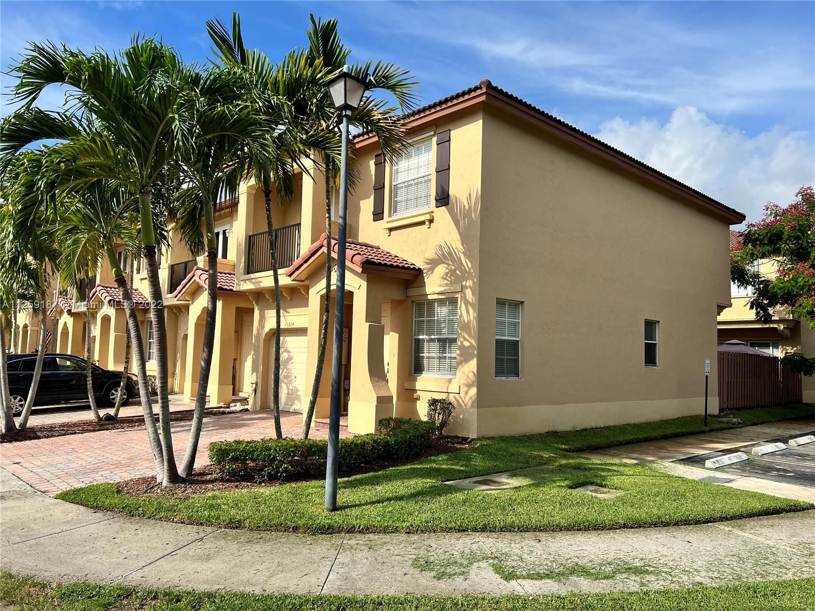 Three Lakes Miami, FL 33186 - Photo 4 of 23 a yellow house with trees in front of it
