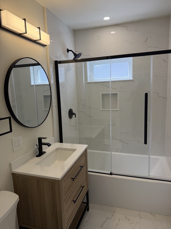 60-62 Wellsmere Road, Unit 1 Boston, MA 02131 - Photo 10 of 19 a bathroom with a sink a mirror and a shower
