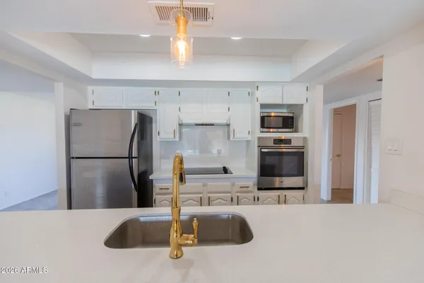 a kitchen with a sink a refrigerator and window