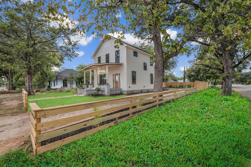 Rear view of property with covered porch