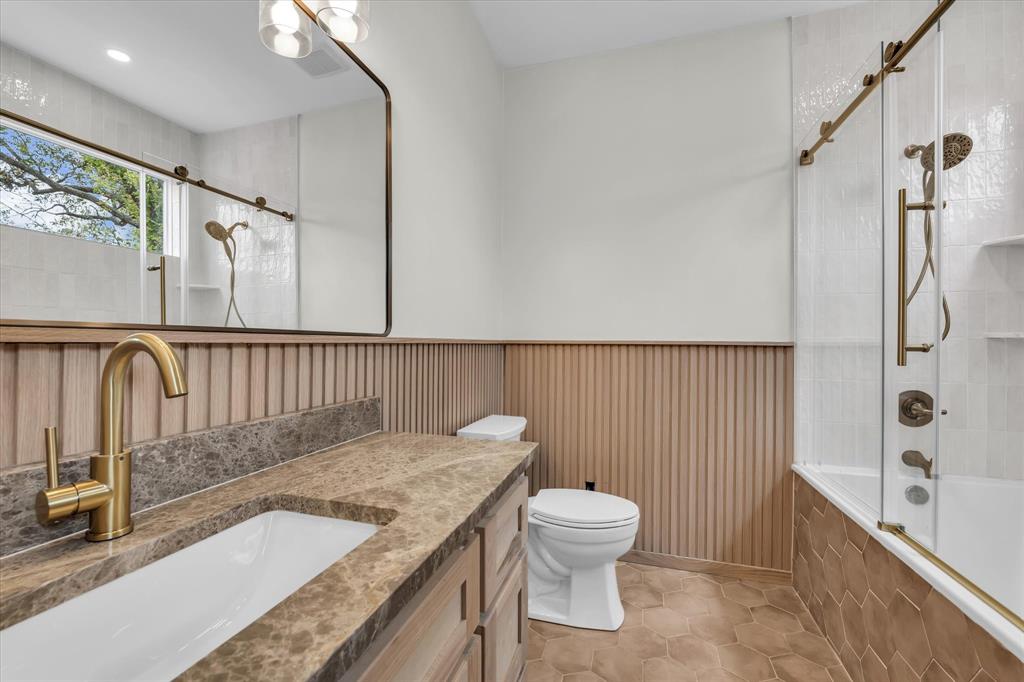 718 Tyler Street Waco, TX 76704 - Photo 14 of 39 a bathroom with a granite countertop sink a toilet and shower