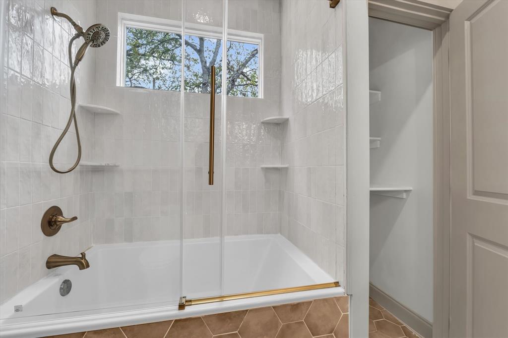 718 Tyler Street Waco, TX 76704 - Photo 16 of 39 a bathroom with a bath tub with a shower