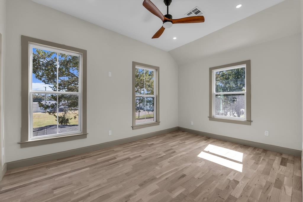 718 Tyler Street Waco, TX 76704 - Photo 20 of 39 a view of empty room with window and wooden floor
