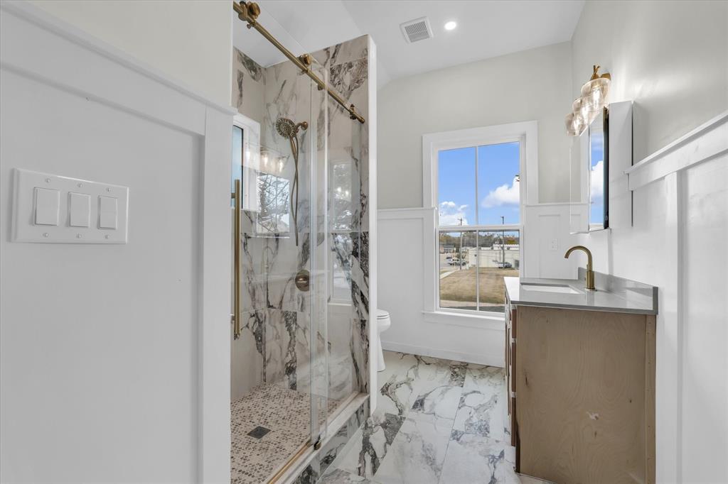 718 Tyler Street Waco, TX 76704 - Photo 21 of 39 a bathroom with a shower sink and mirror
