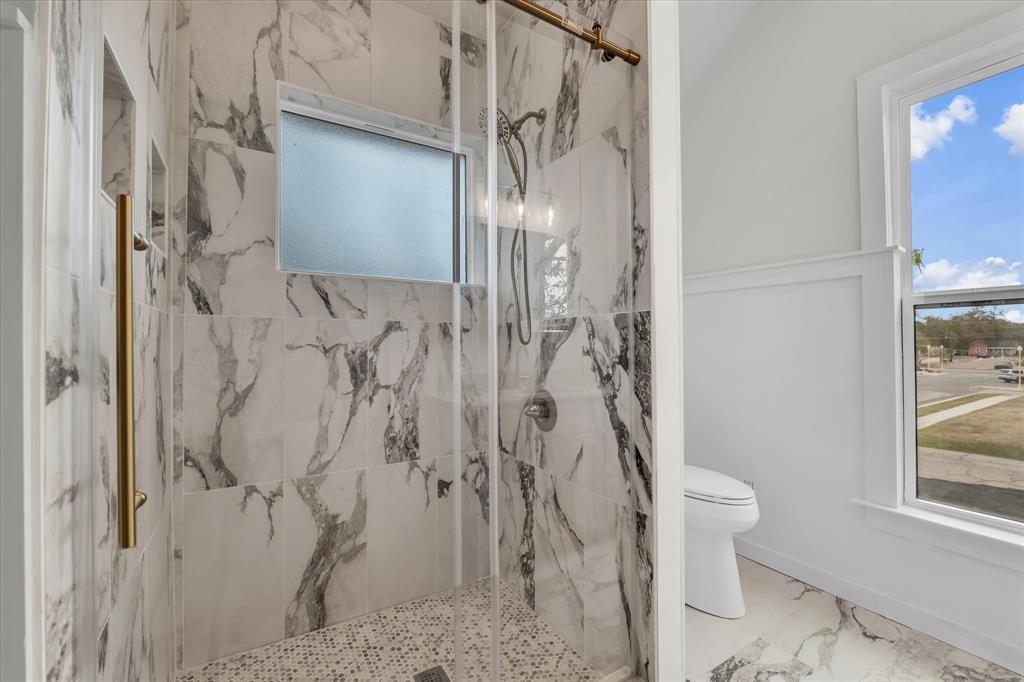 718 Tyler Street Waco, TX 76704 - Photo 22 of 39 a bathroom with a shower and toilet