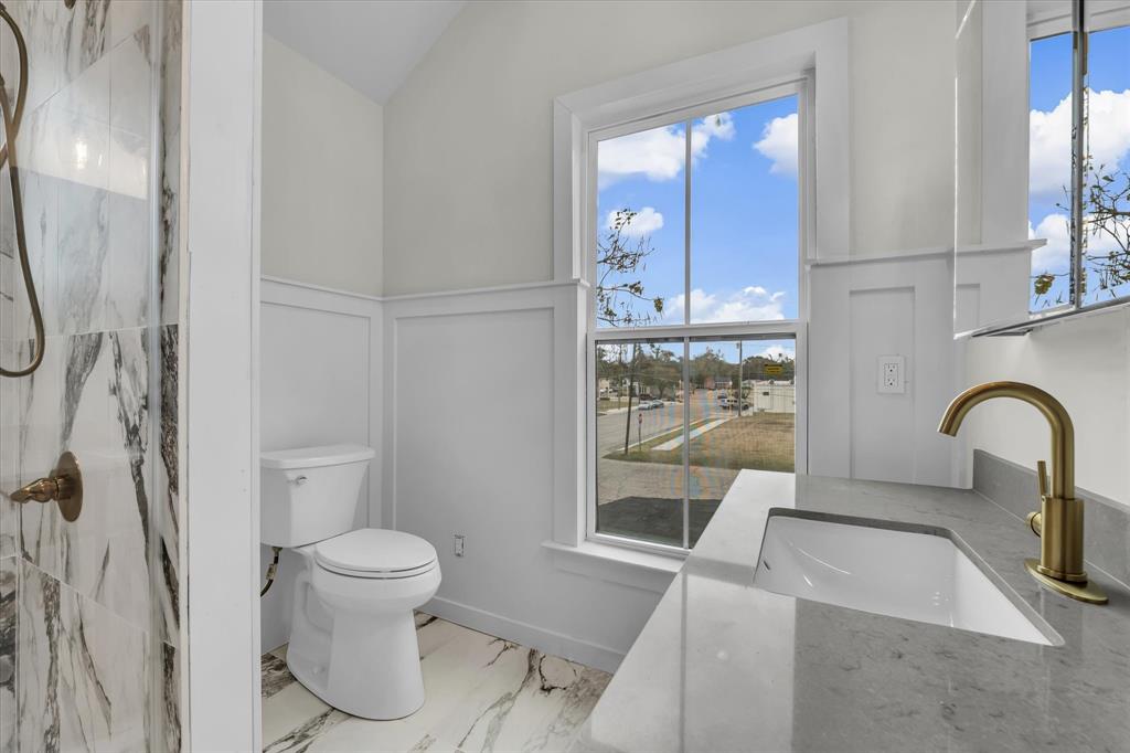 718 Tyler Street Waco, TX 76704 - Photo 24 of 39 a bathroom with a sink toilet and shower