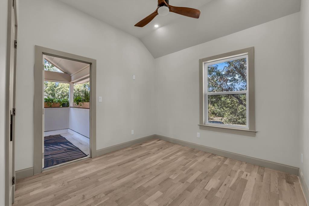 718 Tyler Street Waco, TX 76704 - Photo 29 of 39 an empty room with wooden floor cabinet and windows