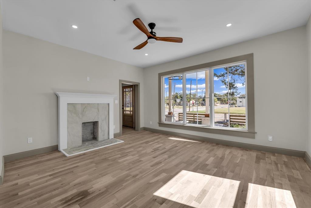 718 Tyler Street Waco, TX 76704 - Photo 7 of 39 a view of an empty room with a window and wooden floor