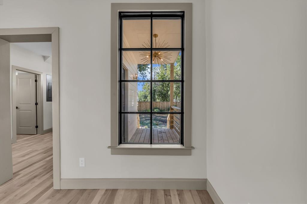 718 Tyler Street Waco, TX 76704 - Photo 9 of 39 a view of a small space with wooden floor and a window