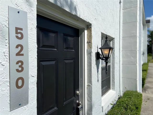 a kitchen with stainless steel appliances granite countertop a refrigerator a stove and a sink