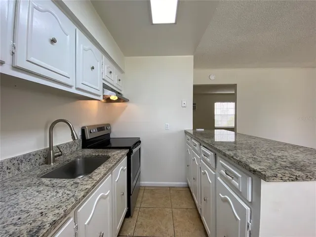 a view of a kitchen with a sink dishwasher and a refrigerator