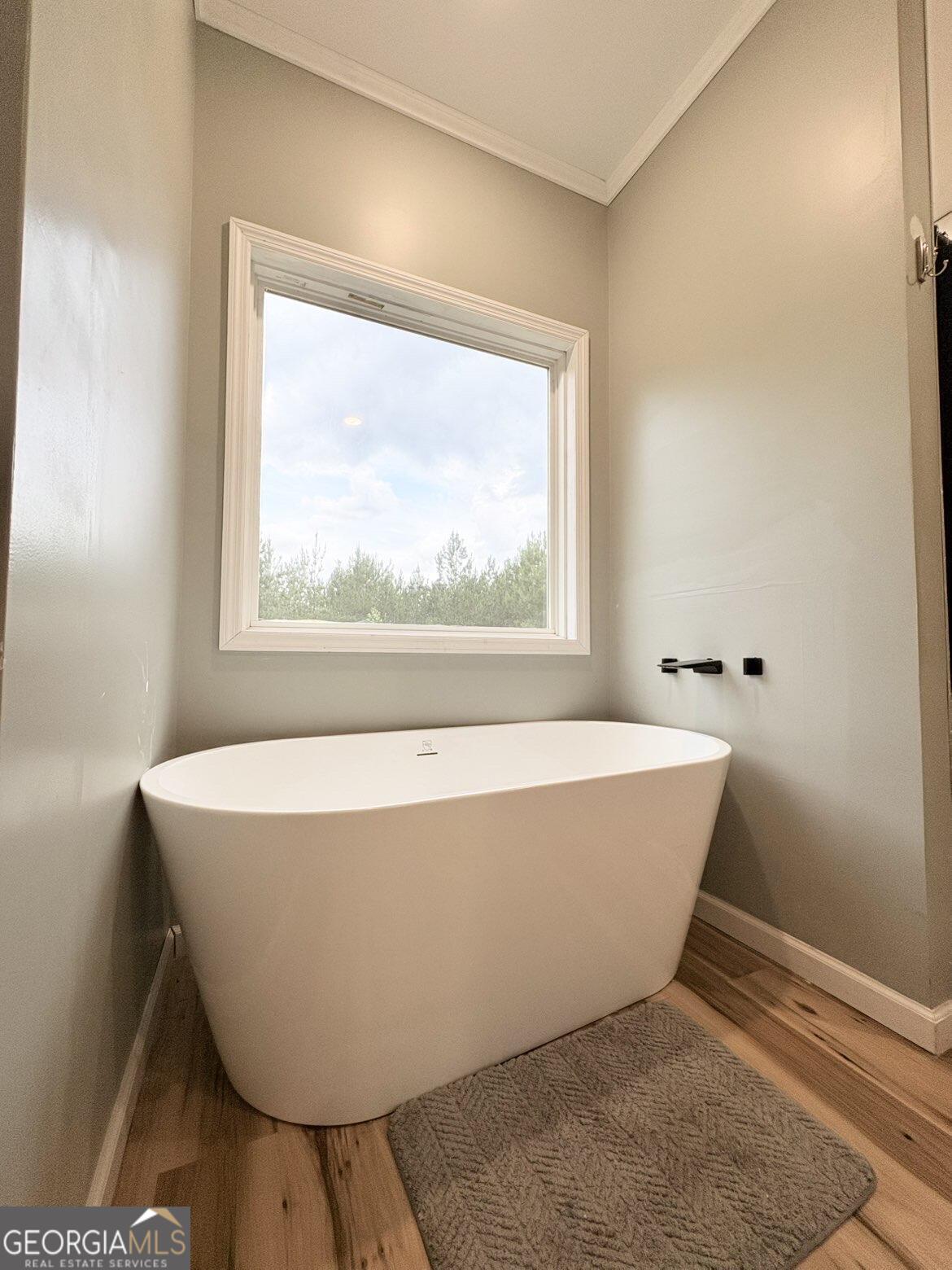 210 St Galilee Road Swainsboro, GA 30401 - Photo 10 of 18 a white bath tub sitting in a bathroom next to a window