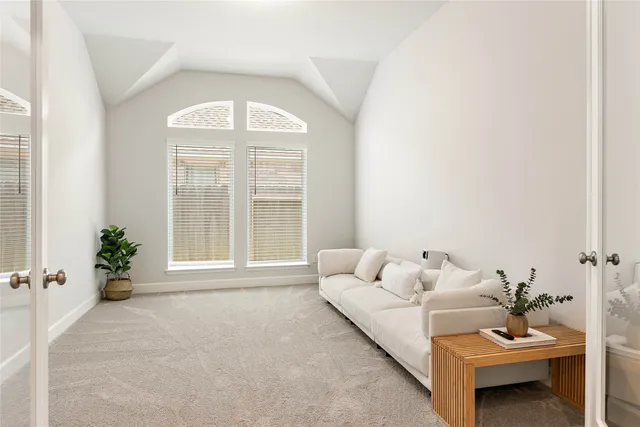 a large white room with kitchen view and wooden floor