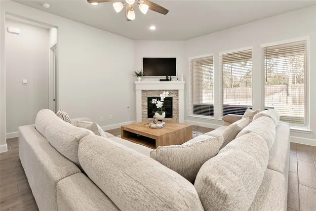 a living room with furniture flat screen tv and a fireplace