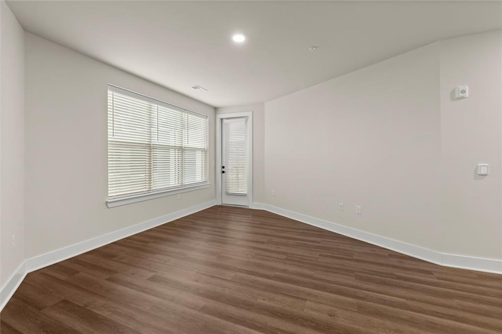 2648 Sandy Plains Road, Unit 422 Marietta, GA 30066 - Photo 11 of 37 wooden floor in an empty room with a window
