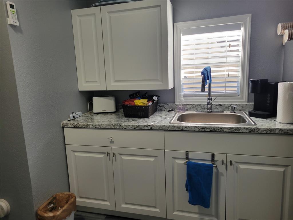 511 Southwest 39th Trace Okeechobee, FL 34974 - Photo 16 of 16 a kitchen with granite countertop white cabinets and sink