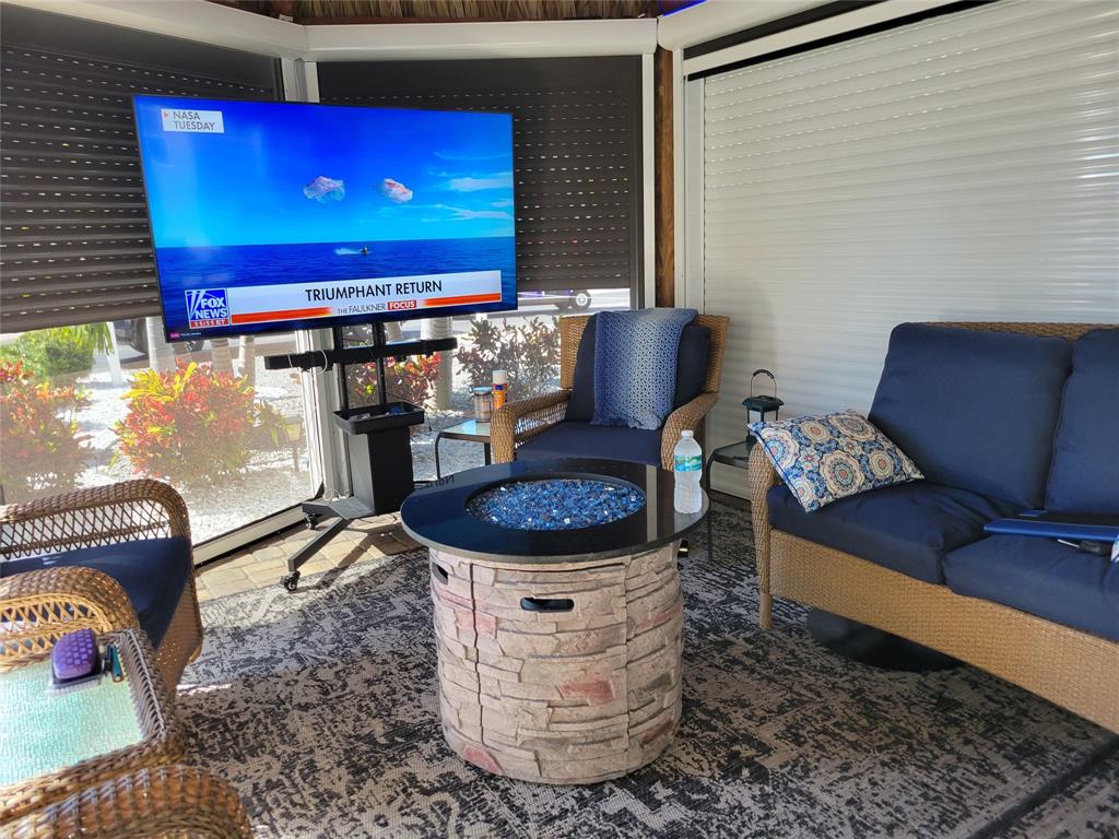 511 Southwest 39th Trace Okeechobee, FL 34974 - Photo 5 of 16 a living room with furniture and a flat screen tv