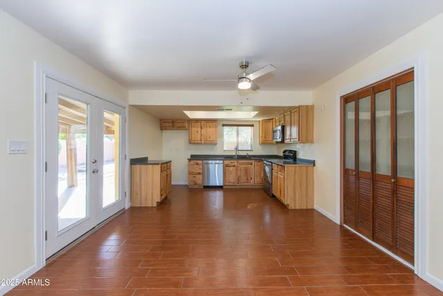 a kitchen with stainless steel appliances granite countertop a stove a sink and a microwave