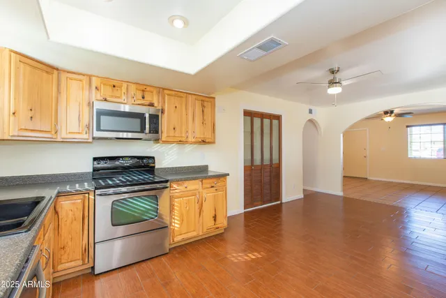 a kitchen with granite countertop a sink and cabinets