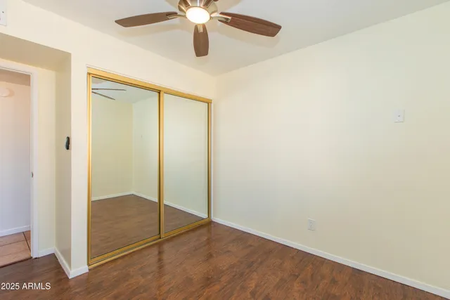a view of a room with wooden floor and white walls