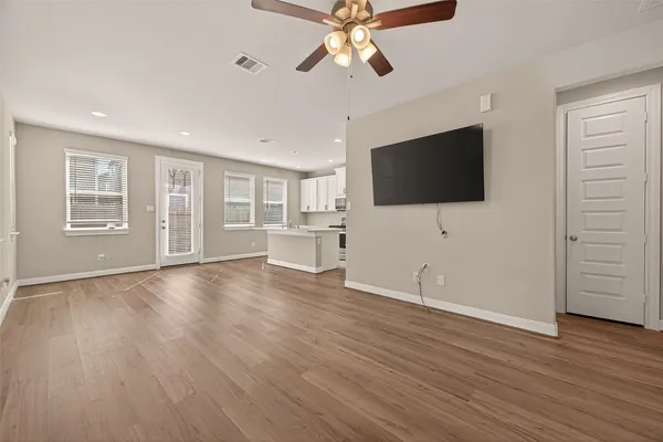 a living room with a ceiling fan and a window
