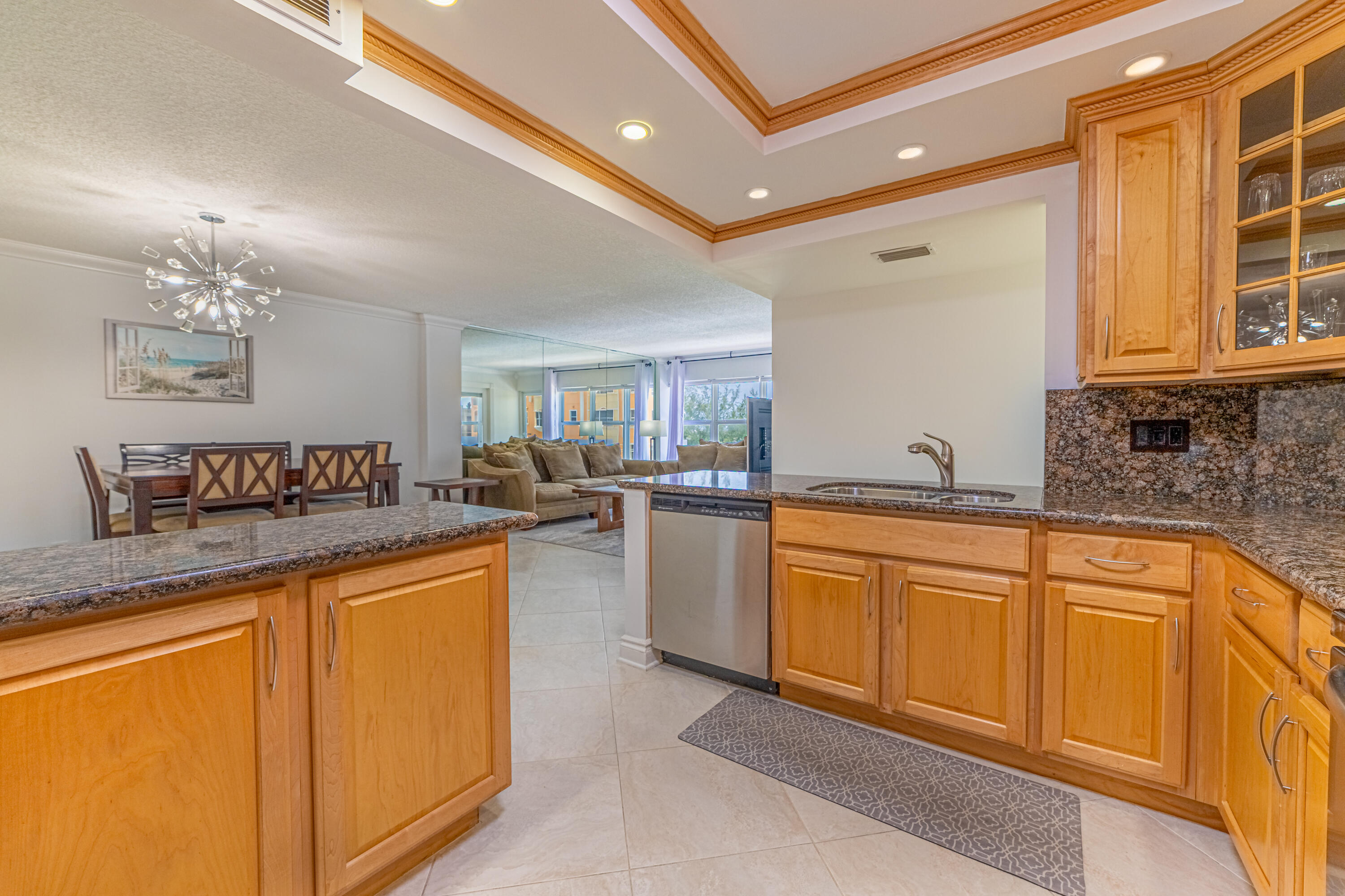 405 North Ocean Boulevard, Unit 507 Pompano Beach, FL 33062 - Photo 15 of 38 a large kitchen with stainless steel appliances granite countertop a sink and cabinets