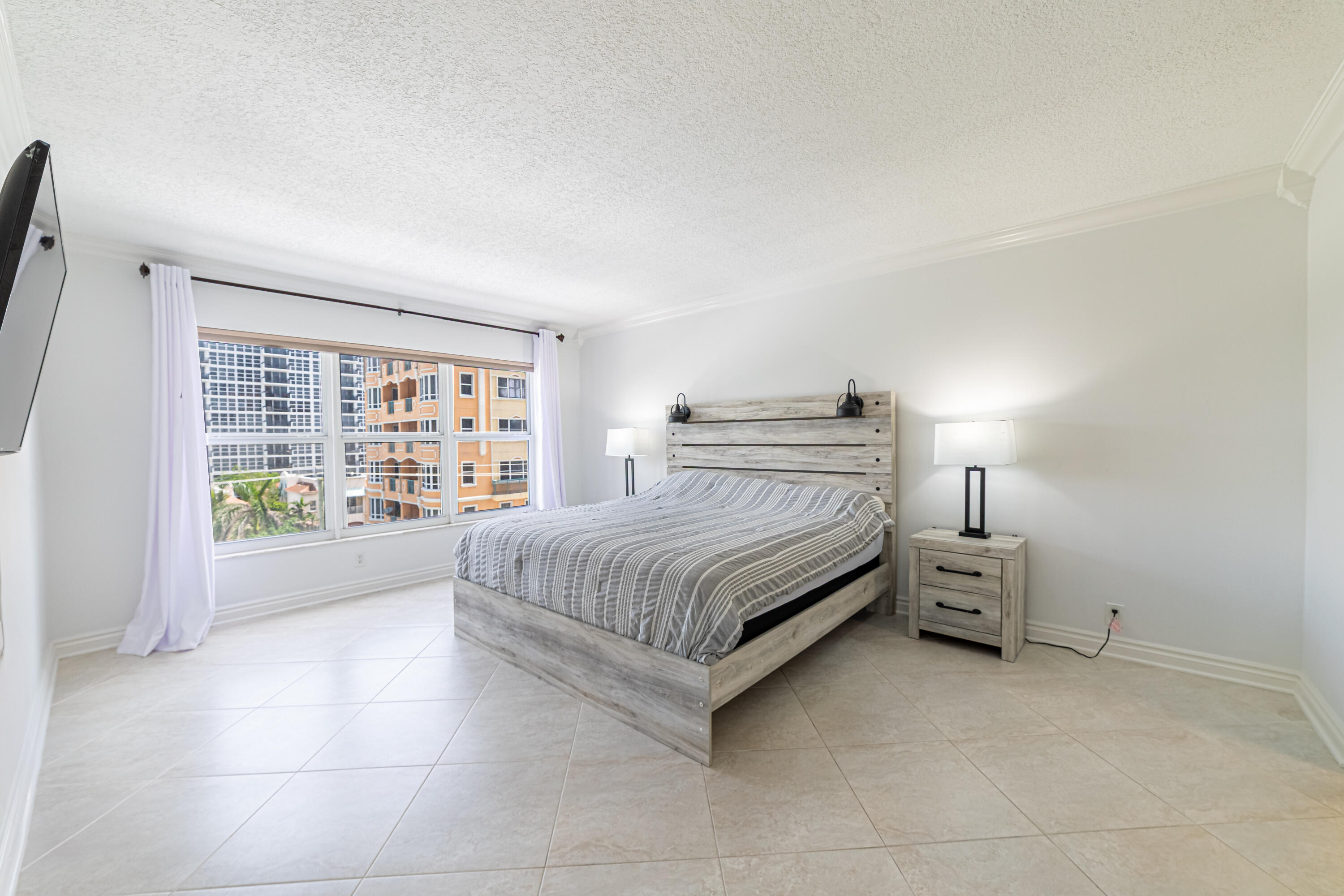 405 North Ocean Boulevard, Unit 507 Pompano Beach, FL 33062 - Photo 16 of 38 a spacious bedroom with a bed and a large window