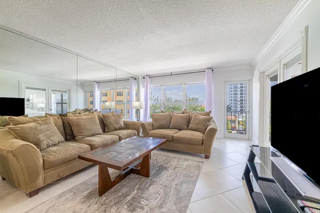 a kitchen with stainless steel appliances granite countertop a refrigerator a stove a sink and a microwave