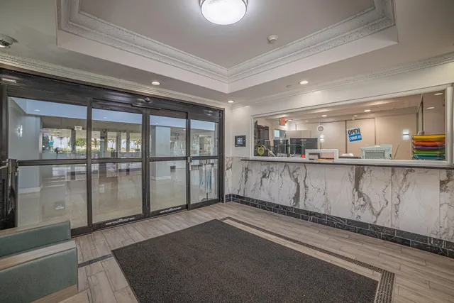 a living room with furniture and a book shelf