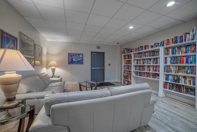 a living room with lots of chairs and a flat screen tv