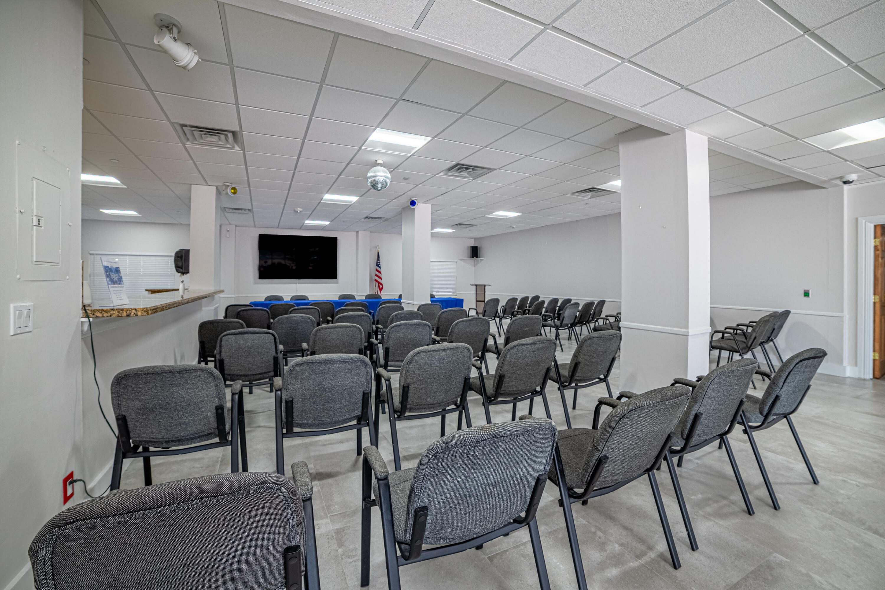 405 North Ocean Boulevard, Unit 507 Pompano Beach, FL 33062 - Photo 25 of 38 a living room with lots of chairs and a flat screen tv