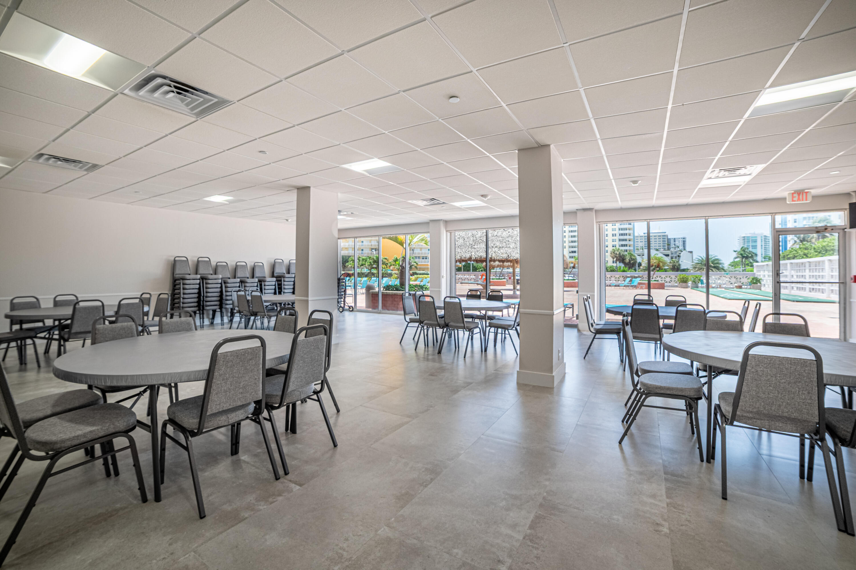 405 North Ocean Boulevard, Unit 507 Pompano Beach, FL 33062 - Photo 26 of 38 a dining room with furniture water view and a floor to ceiling window
