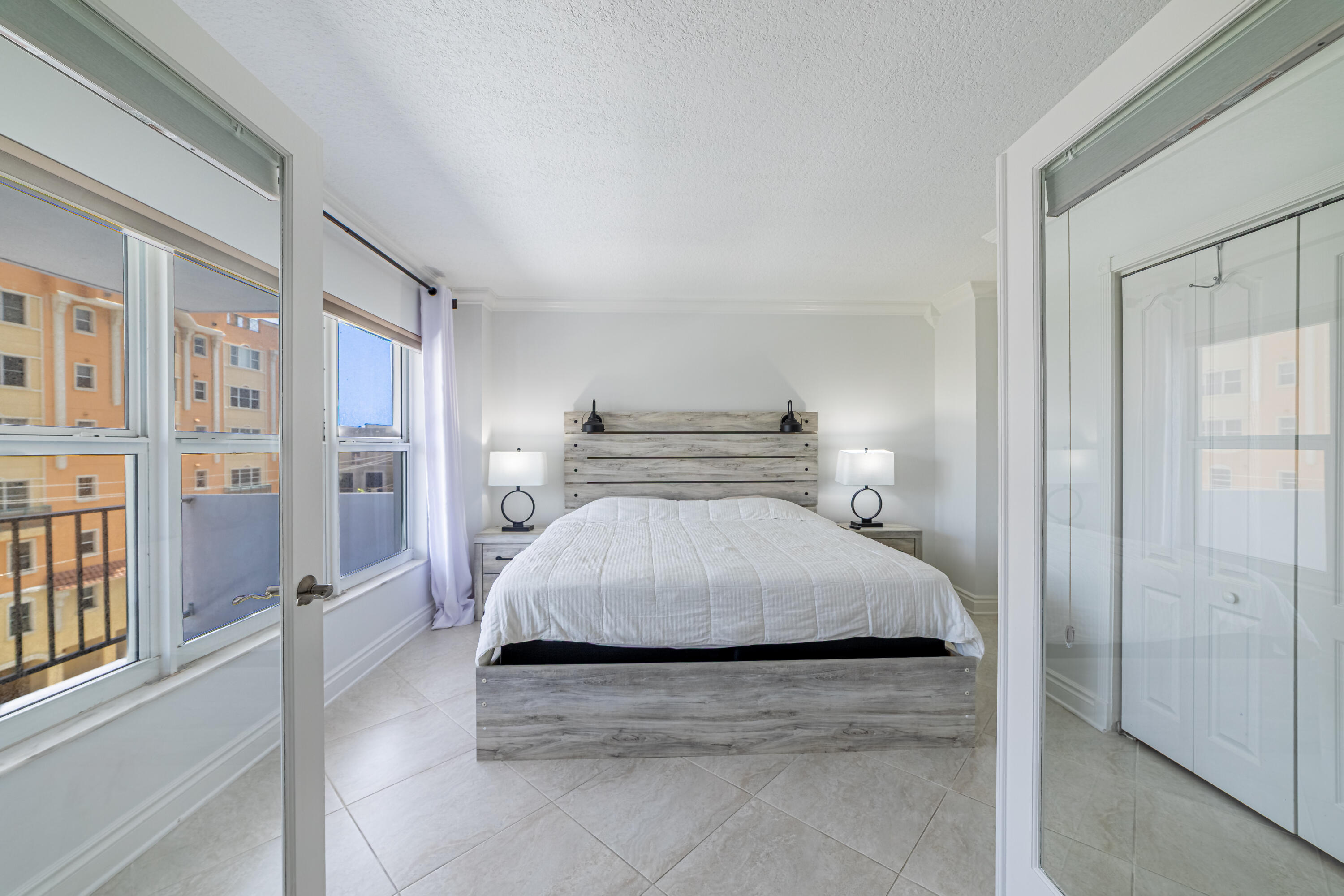 405 North Ocean Boulevard, Unit 507 Pompano Beach, FL 33062 - Photo 4 of 38 a spacious bedroom with a bed and glass door