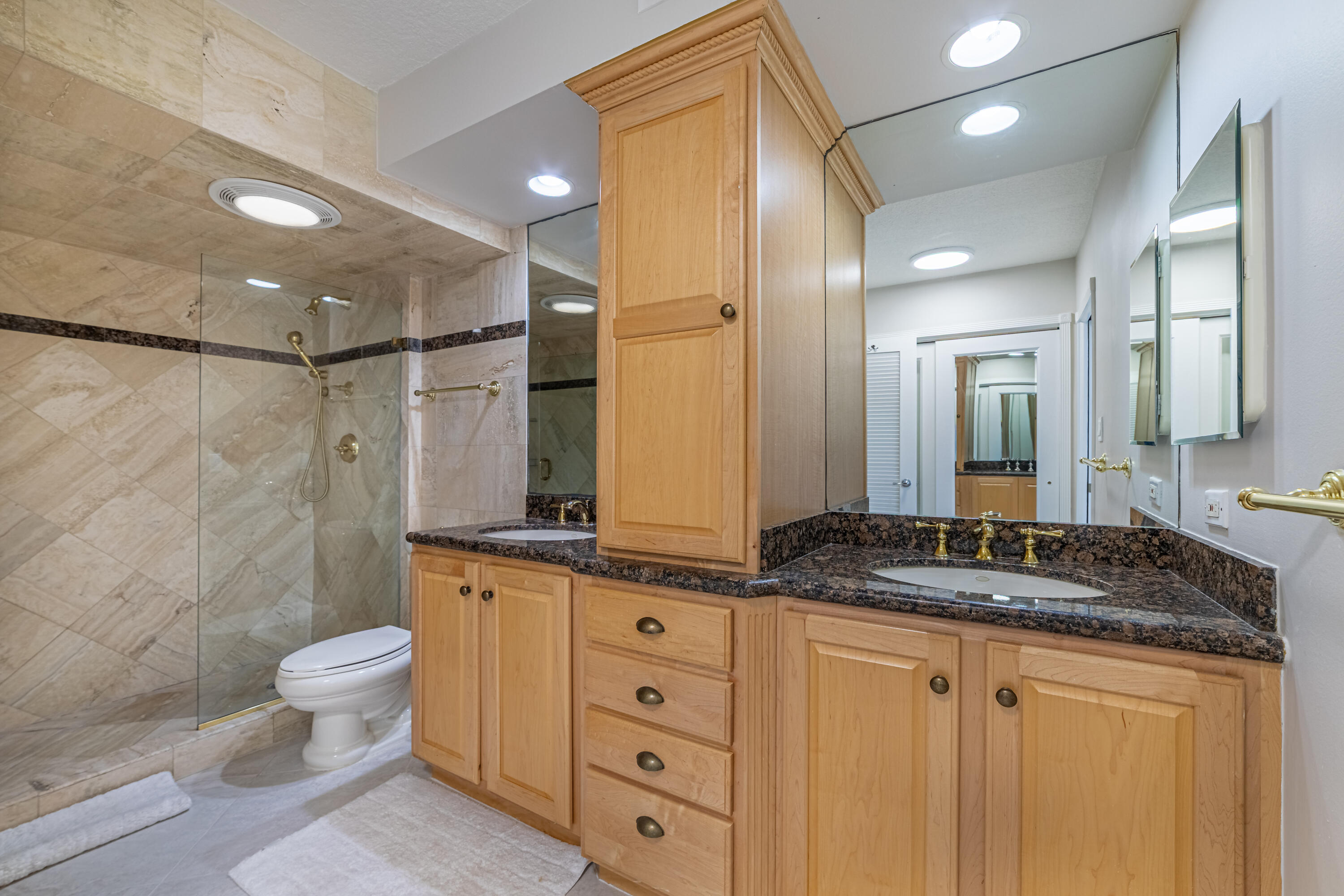 405 North Ocean Boulevard, Unit 507 Pompano Beach, FL 33062 - Photo 6 of 38 a bathroom with a granite countertop sink toilet a mirror and shower