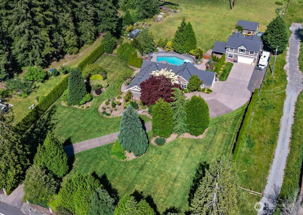 21713 45th Avenue Southeast Bothell, WA 98021 - Photo 1 of 40 an aerial view of a house with a garden and lake view