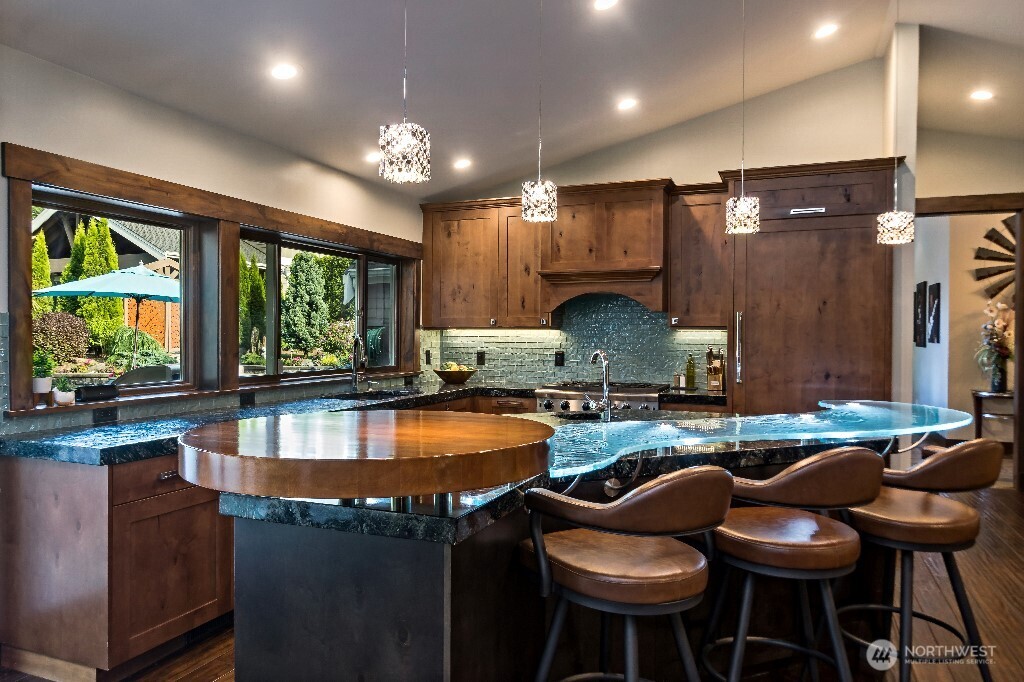 21713 45th Avenue Southeast Bothell, WA 98021 - Photo 13 of 40 a kitchen with stainless steel appliances granite countertop table chairs stove and sink