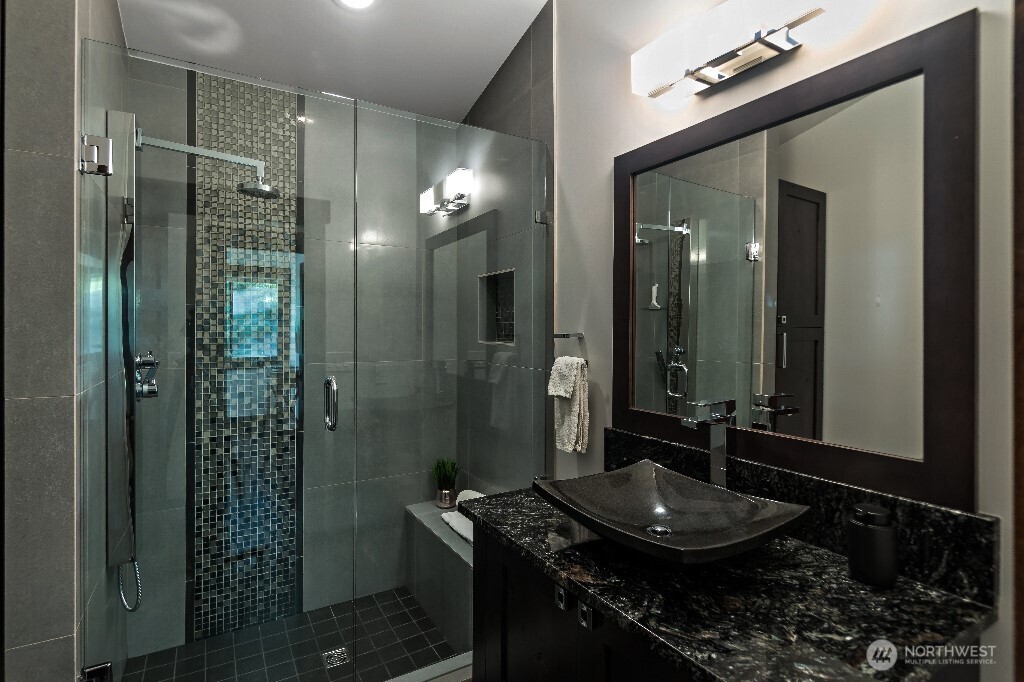 21713 45th Avenue Southeast Bothell, WA 98021 - Photo 17 of 40 a bathroom with a granite countertop sink a mirror and shower