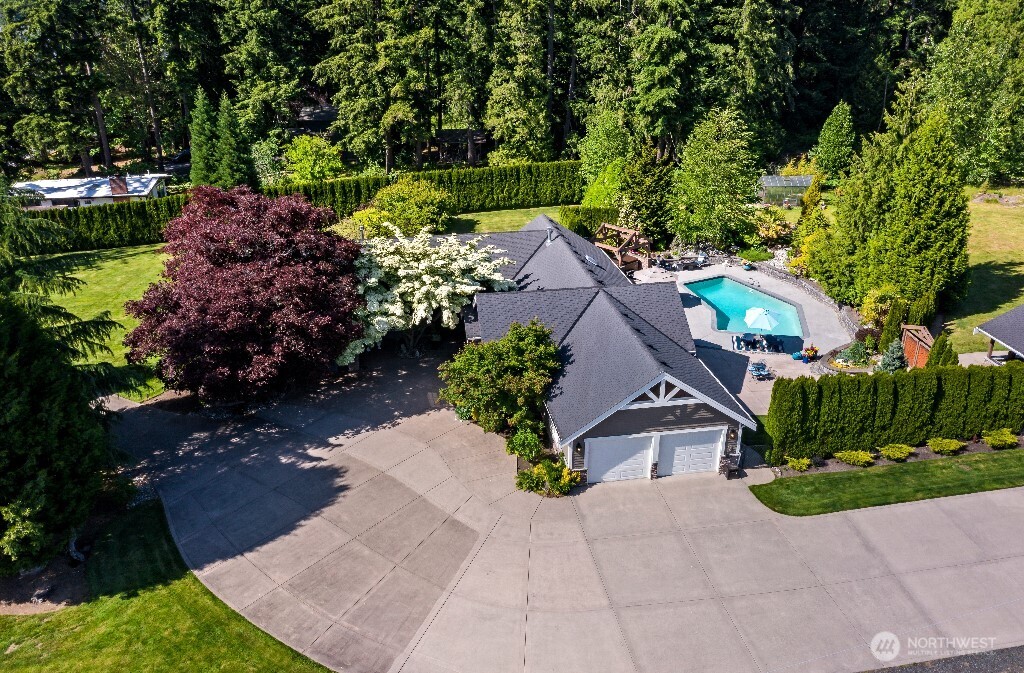 21713 45th Avenue Southeast Bothell, WA 98021 - Photo 2 of 40 a front view of a house with a yard and a garden