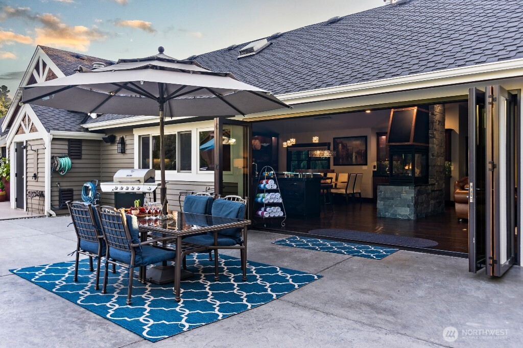 21713 45th Avenue Southeast Bothell, WA 98021 - Photo 28 of 40 a view of a patio with table and chairs under an umbrella