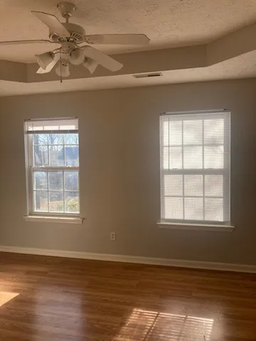 wooden floor in an empty room with a window