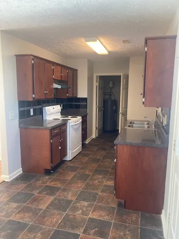 an empty room with wooden floor and door