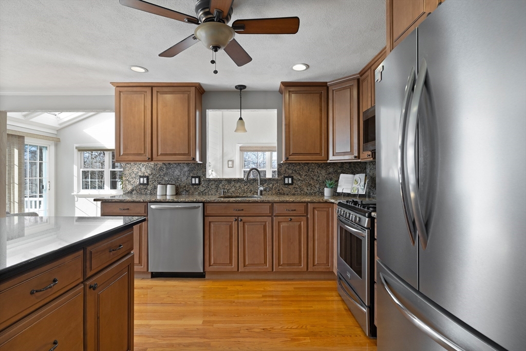 11 Clearview Road Stoneham, MA 02180 - Photo 13 of 42 a kitchen with stainless steel appliances granite countertop a refrigerator a sink and white cabinets