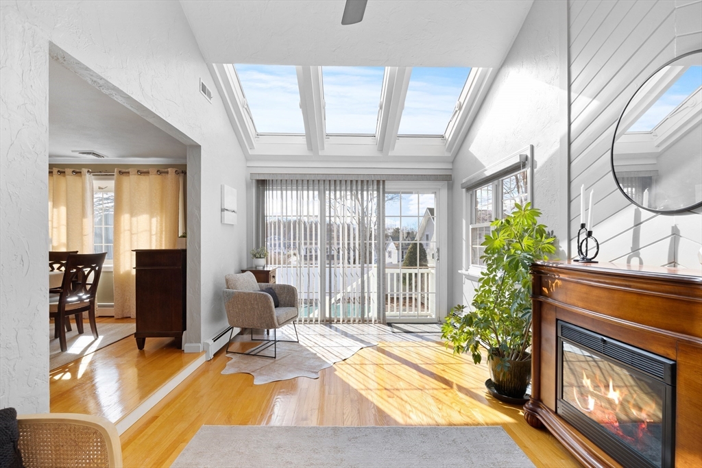 11 Clearview Road Stoneham, MA 02180 - Photo 14 of 42 a living room with furniture a fireplace and potted plants