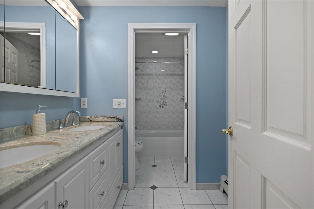 11 Clearview Road Stoneham, MA 02180 - Photo 20 of 42 a bathroom with a granite countertop sink and a mirror