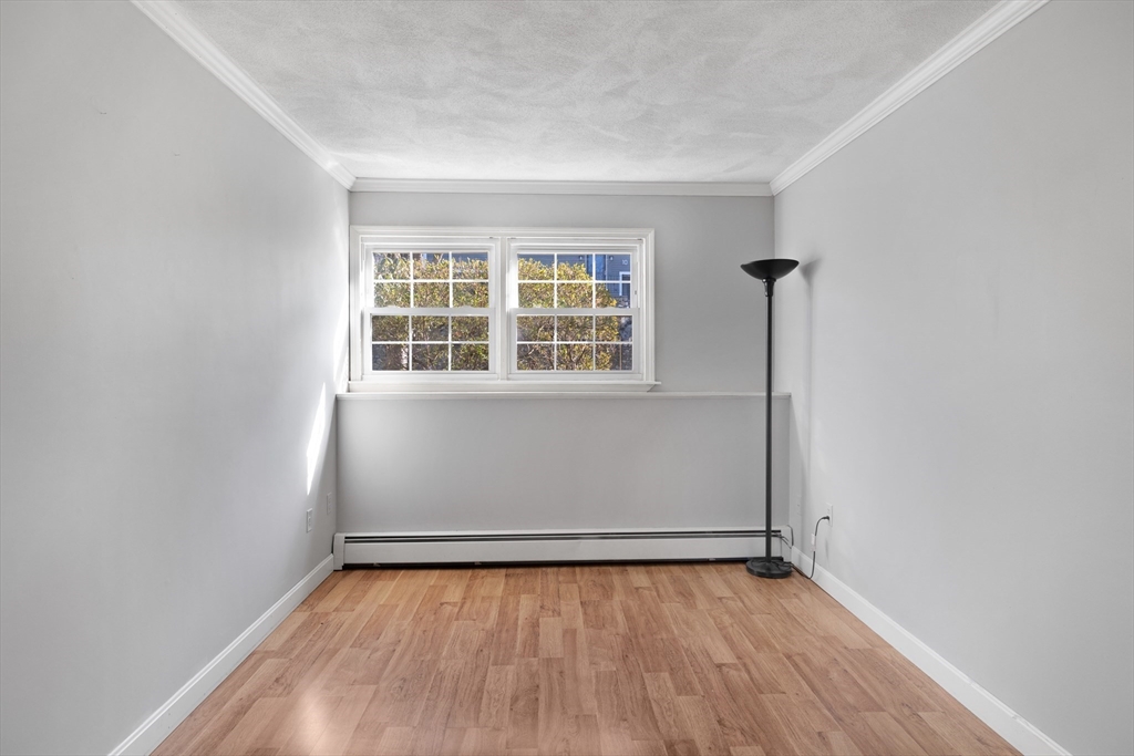11 Clearview Road Stoneham, MA 02180 - Photo 22 of 42 an empty room with wooden floor and windows