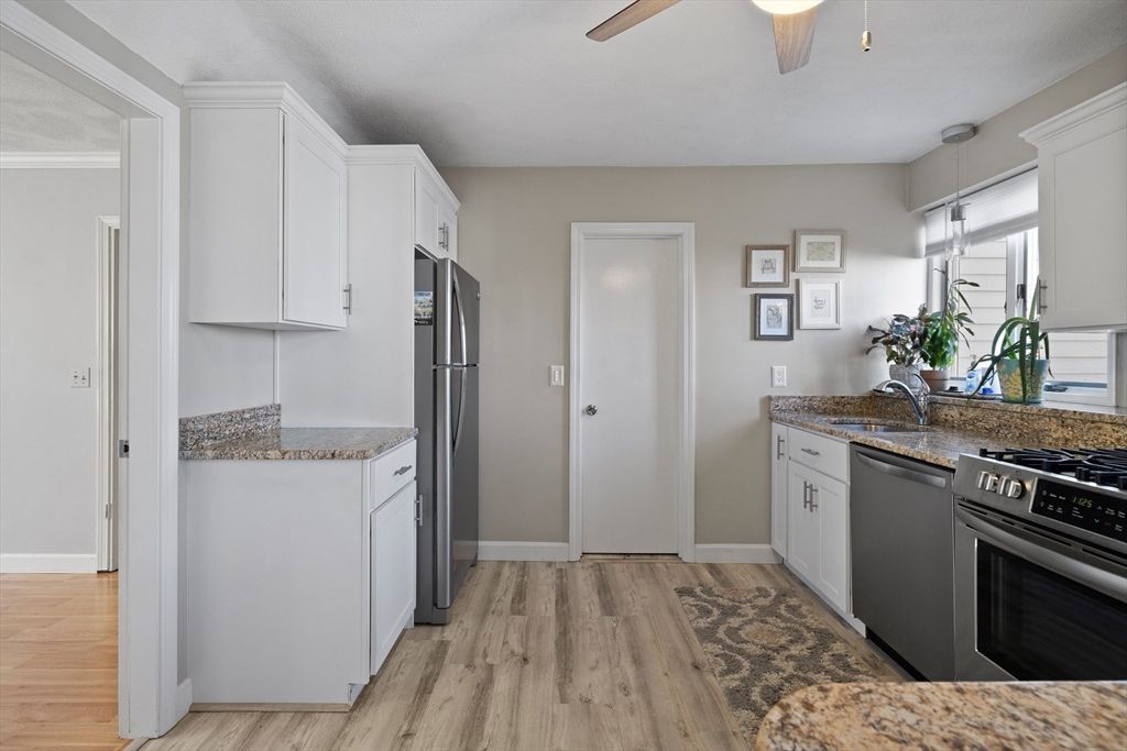 11 Clearview Road Stoneham, MA 02180 - Photo 26 of 42 a kitchen with stainless steel appliances granite countertop a refrigerator and a stove top oven
