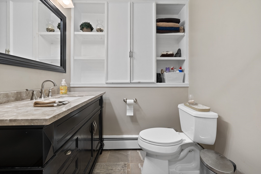 11 Clearview Road Stoneham, MA 02180 - Photo 27 of 42 a bathroom with a toilet a sink and mirror
