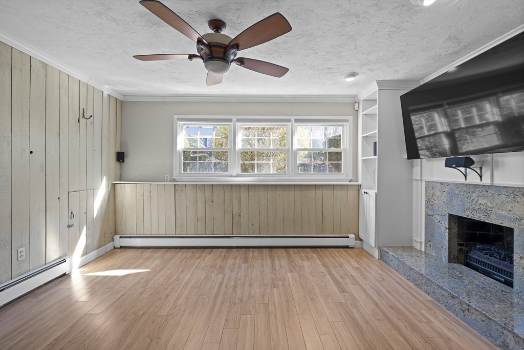 11 Clearview Road Stoneham, MA 02180 - Photo 31 of 42 an empty room with wooden floor a ceiling fan and windows