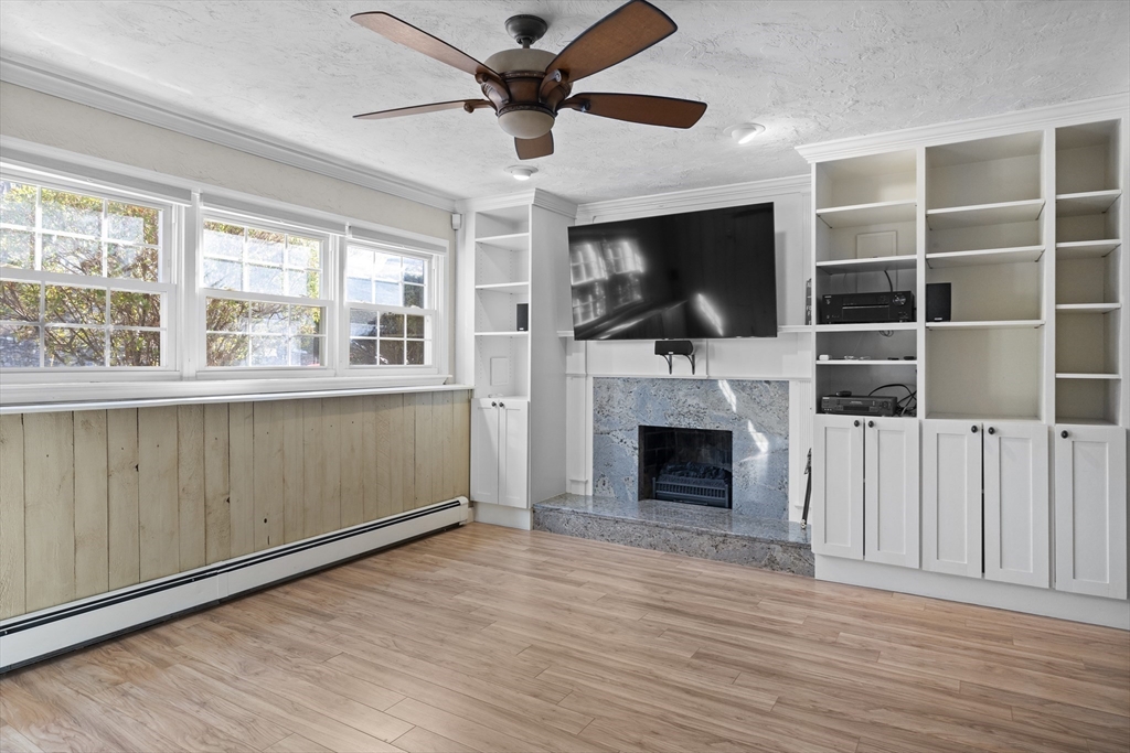 11 Clearview Road Stoneham, MA 02180 - Photo 32 of 42 wooden floor fireplace and windows in an empty room