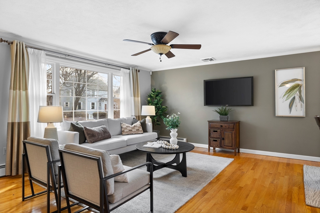 11 Clearview Road Stoneham, MA 02180 - Photo 4 of 42 a living room with furniture a flat screen tv and a large window